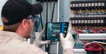 Technician inspecting an electrical box