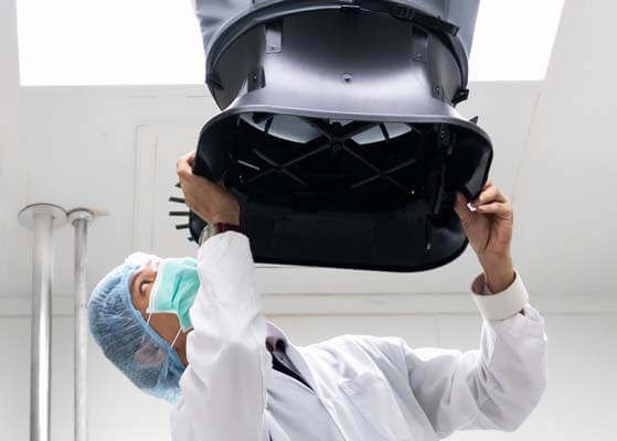 Doctor adjusting equipment in a hospital room