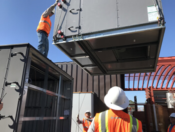 Several Fluidics technicians working on a custom retrofit project at a client facility