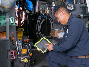 Mobile Service technician completing maintenance services at a client facility